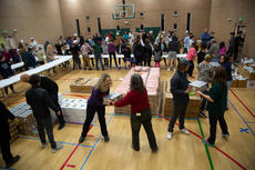 Community members prepare baskets for families in need